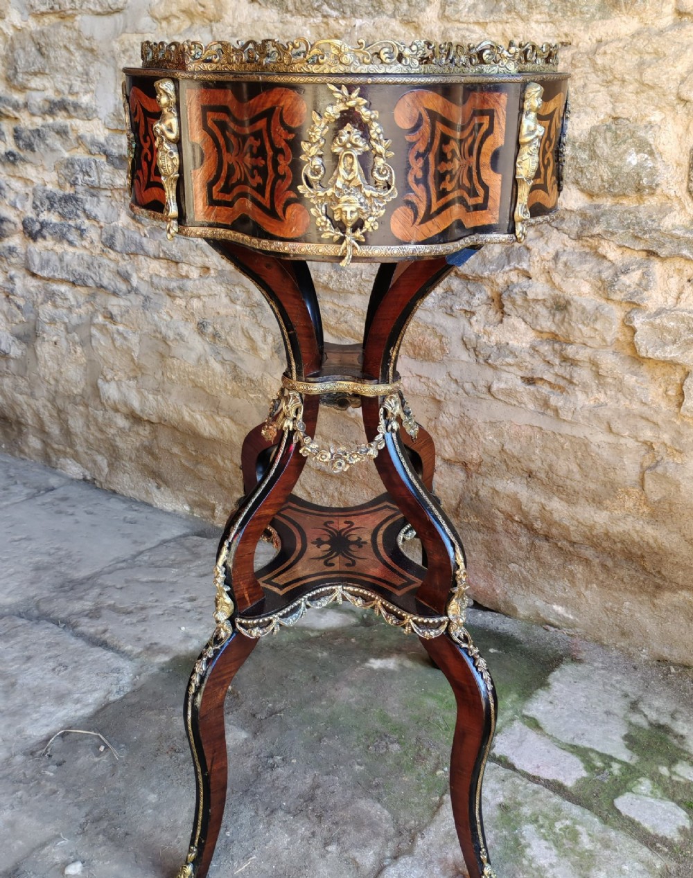A 19th-century French marquetry jardiniere table with intricate wood inlay, ornate gilded mounts, a cherub porcelain plaque, and cabriole legs. View VIII