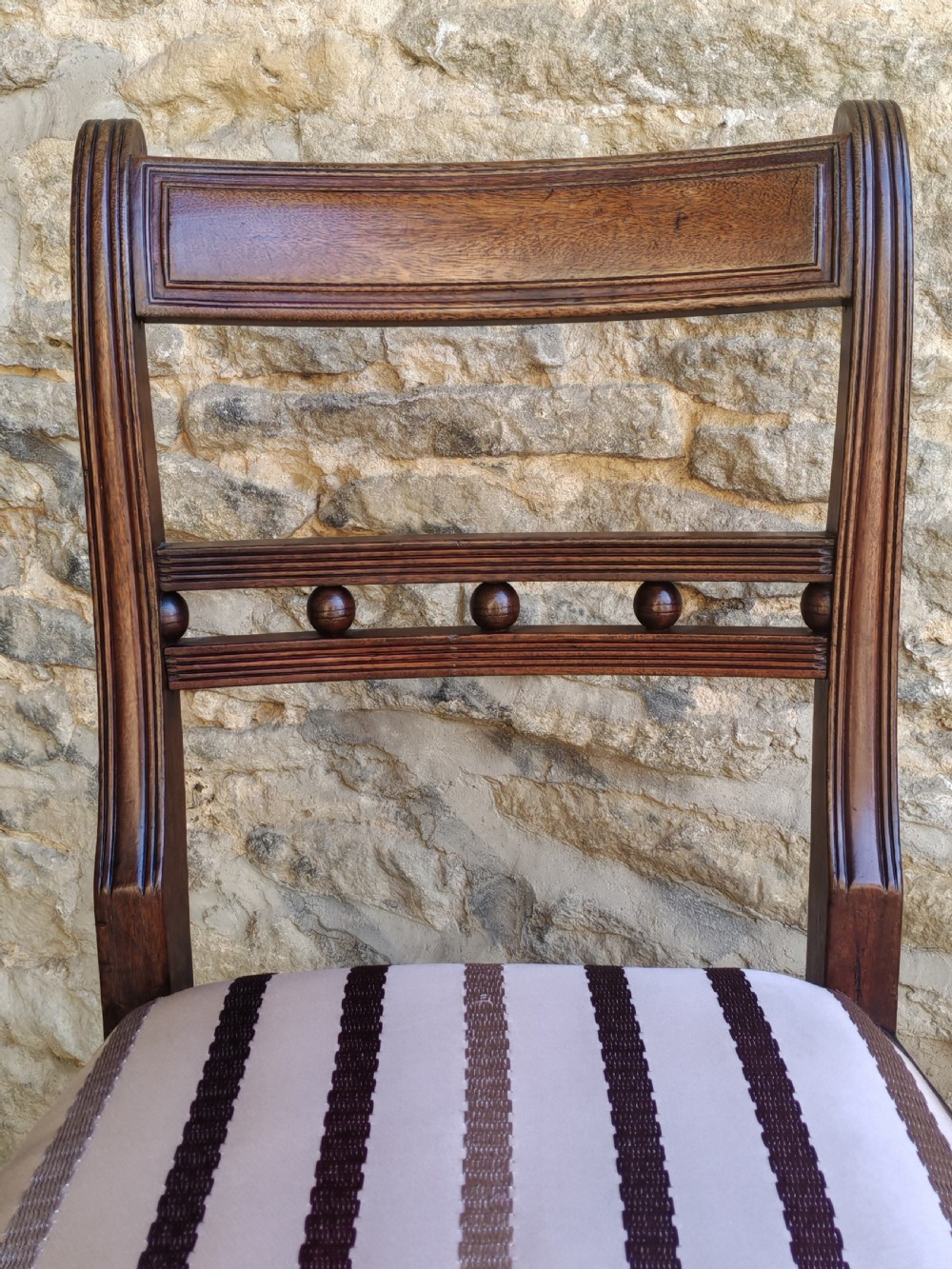 A pair of antique mahogany side chairs featuring reeded frames, a ball-ornamented mid-rail, and striped upholstered seats. View IV