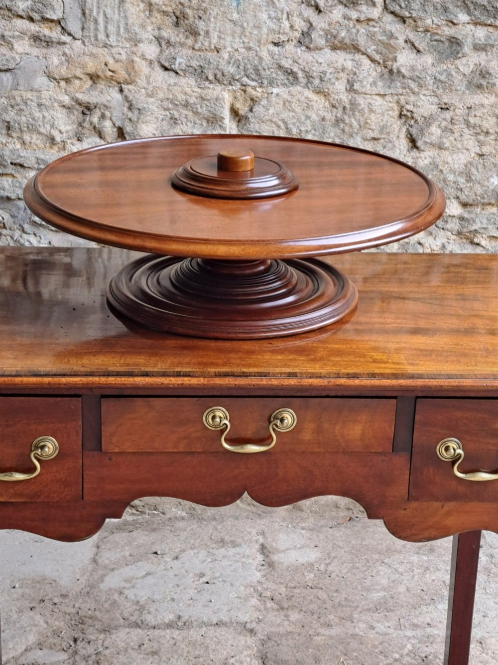 A circular Victorian mahogany Lazy Susan featuring a tiered pedestal base and central turned knob. View II