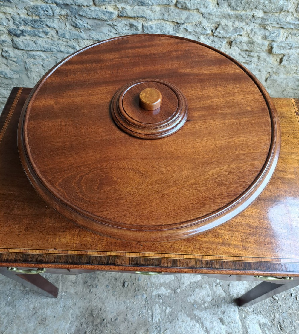 A circular Victorian mahogany Lazy Susan featuring a tiered pedestal base and central turned knob. View III