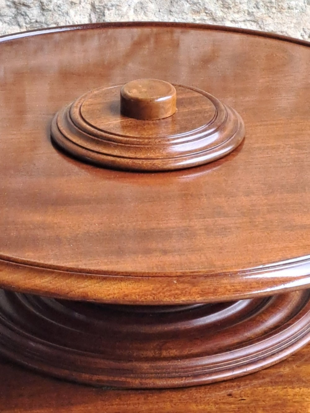 A circular Victorian mahogany Lazy Susan featuring a tiered pedestal base and central turned knob. View IV