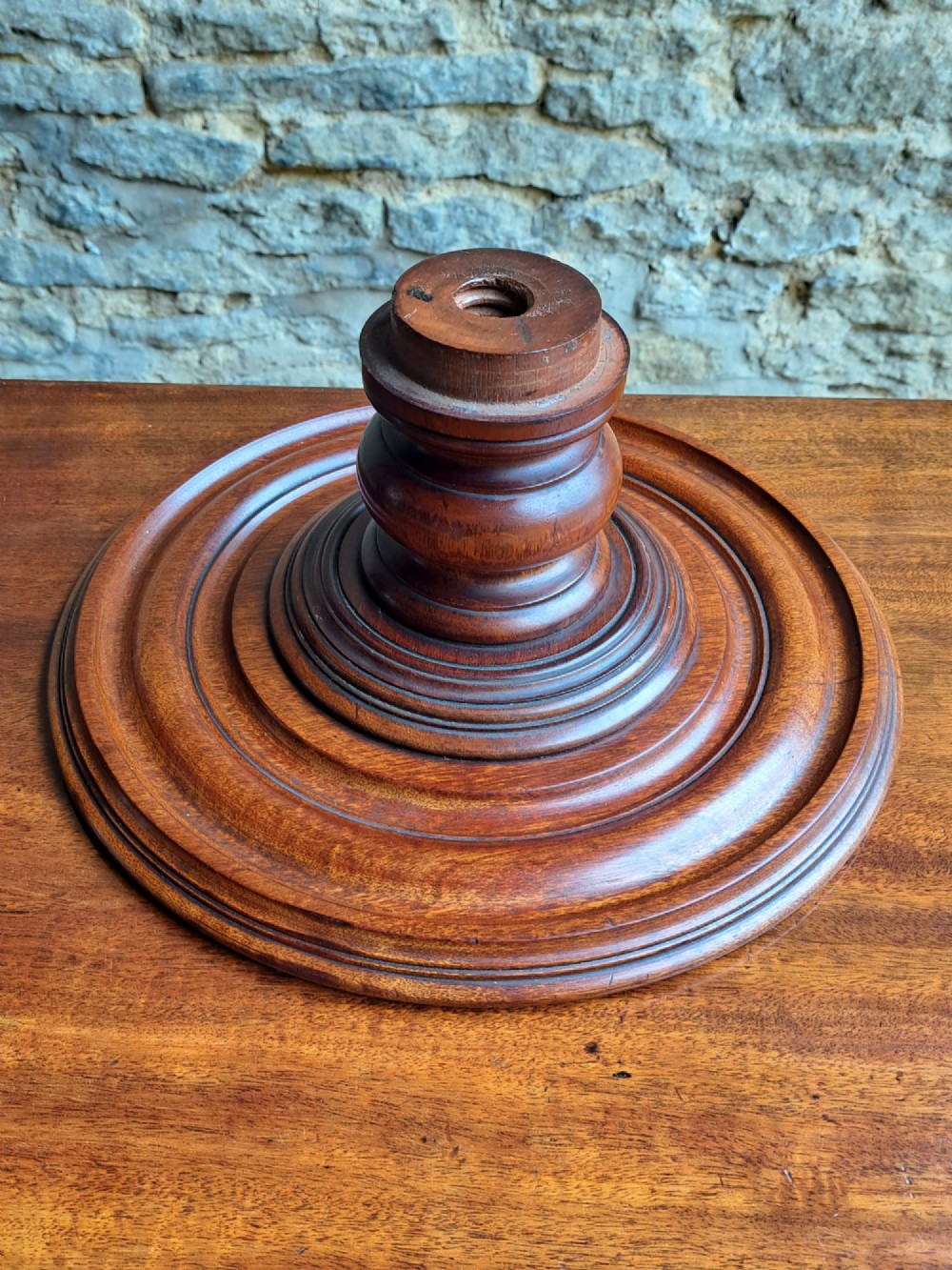 A circular Victorian mahogany Lazy Susan featuring a tiered pedestal base and central turned knob. View VII