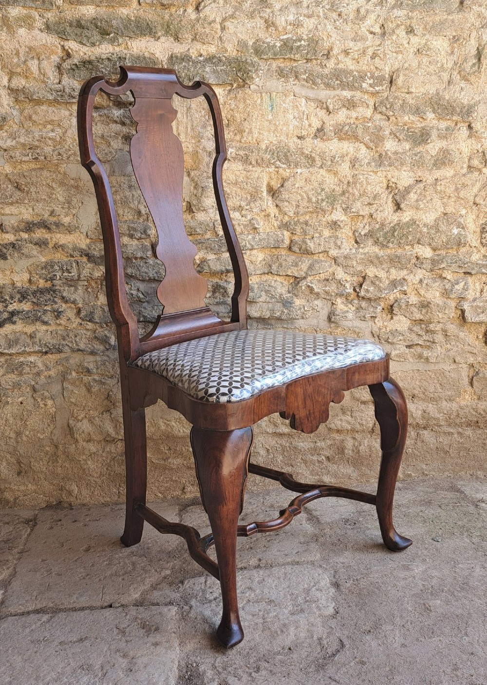 A Queen Anne walnut side chair featuring a shaped vase back splat, patterned drop-in seat, and cabriole front legs with pad feet. View II