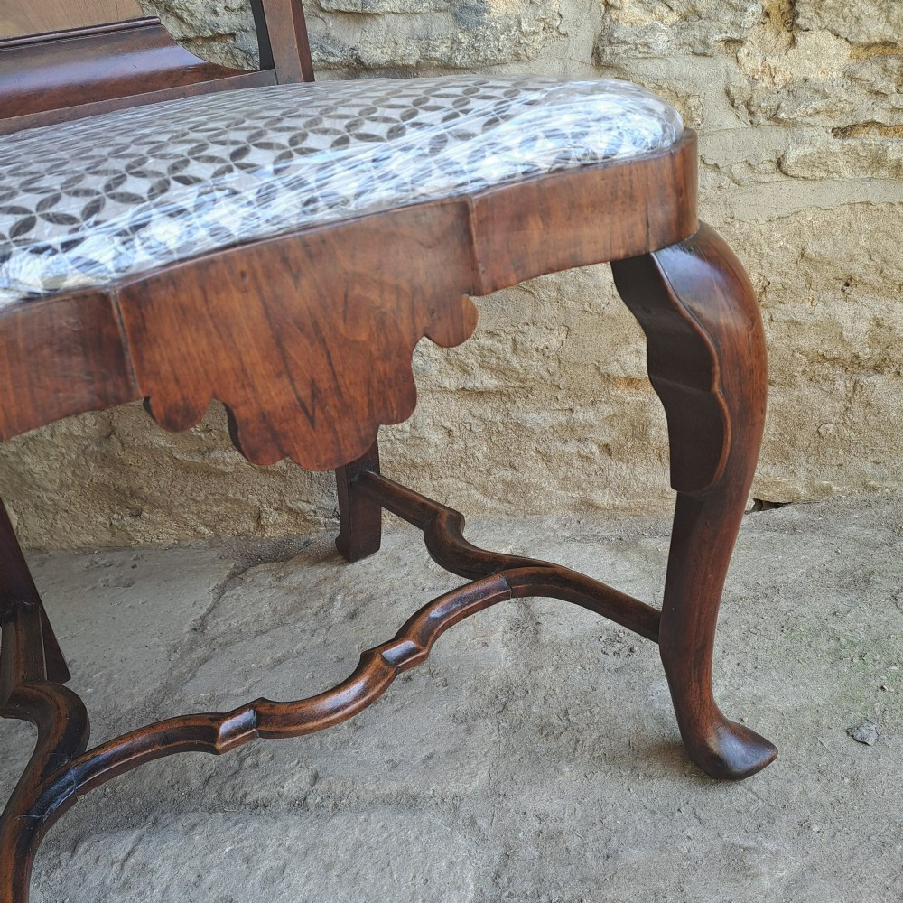 A Queen Anne walnut side chair featuring a shaped vase back splat, patterned drop-in seat, and cabriole front legs with pad feet. View V