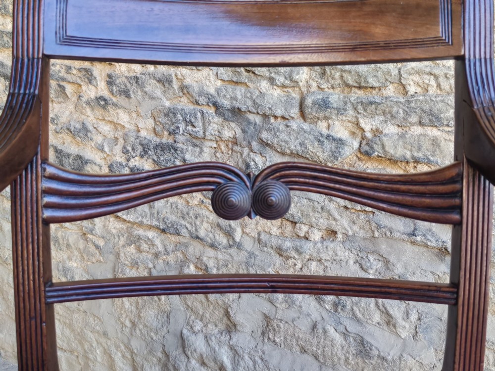 A late Georgian mahogany carver chair featuring carved reeded back rails, curved armrests, and a blue patterned drop-in seat. View III