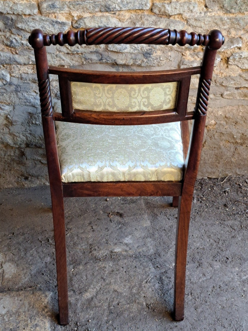 A set of ten 19th-century rosewood dining chairs featuring carved rope-twist top rails, curved sabre legs, and pale green upholstered seats. View VII