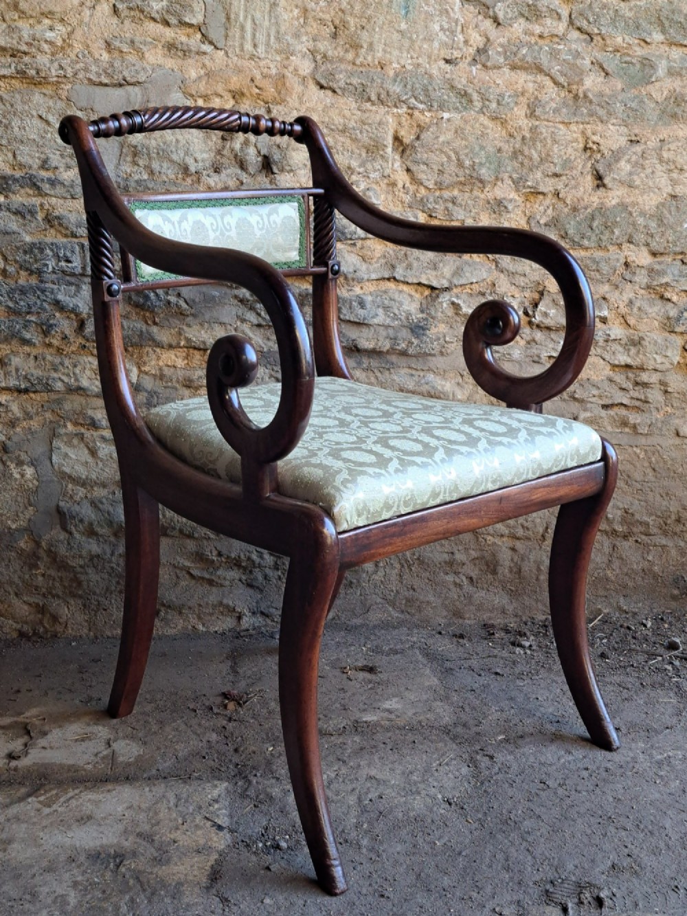A set of ten 19th-century rosewood dining chairs featuring carved rope-twist top rails, curved sabre legs, and pale green upholstered seats. View VIII