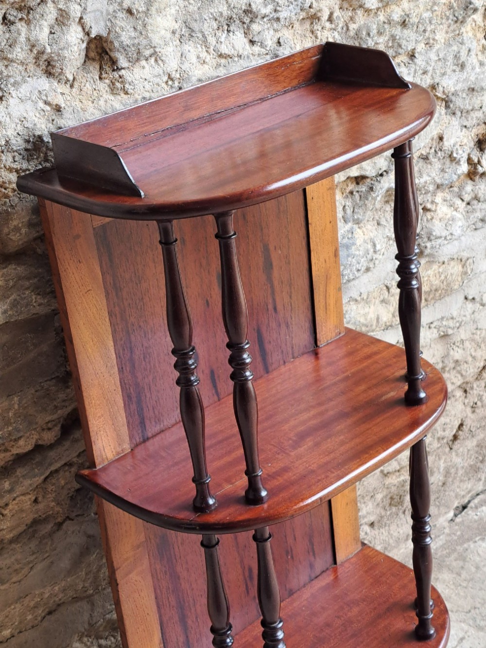 A four-tiered mahogany hanging wall shelf with turned spindle supports and a solid timber backboard. View IV