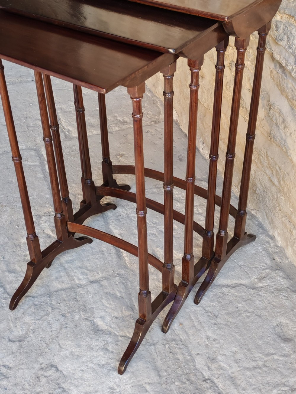A set of three graduated Georgian mahogany nesting tables with slender turned legs and curved stretchers. View VI