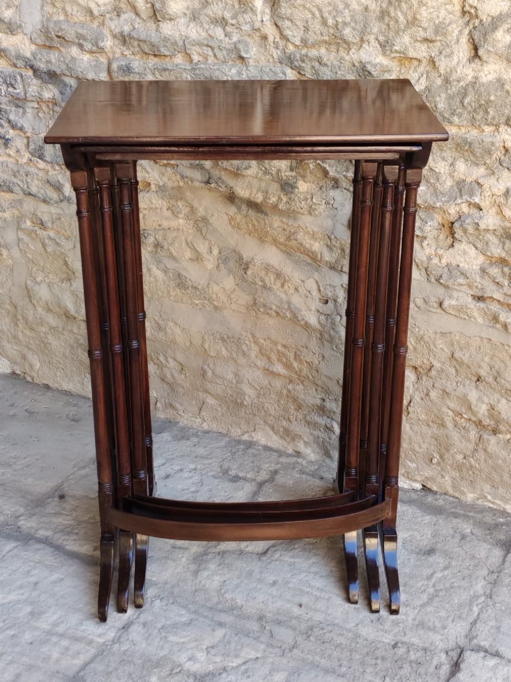 A set of three graduated Georgian mahogany nesting tables with slender turned legs and curved stretchers. View VII