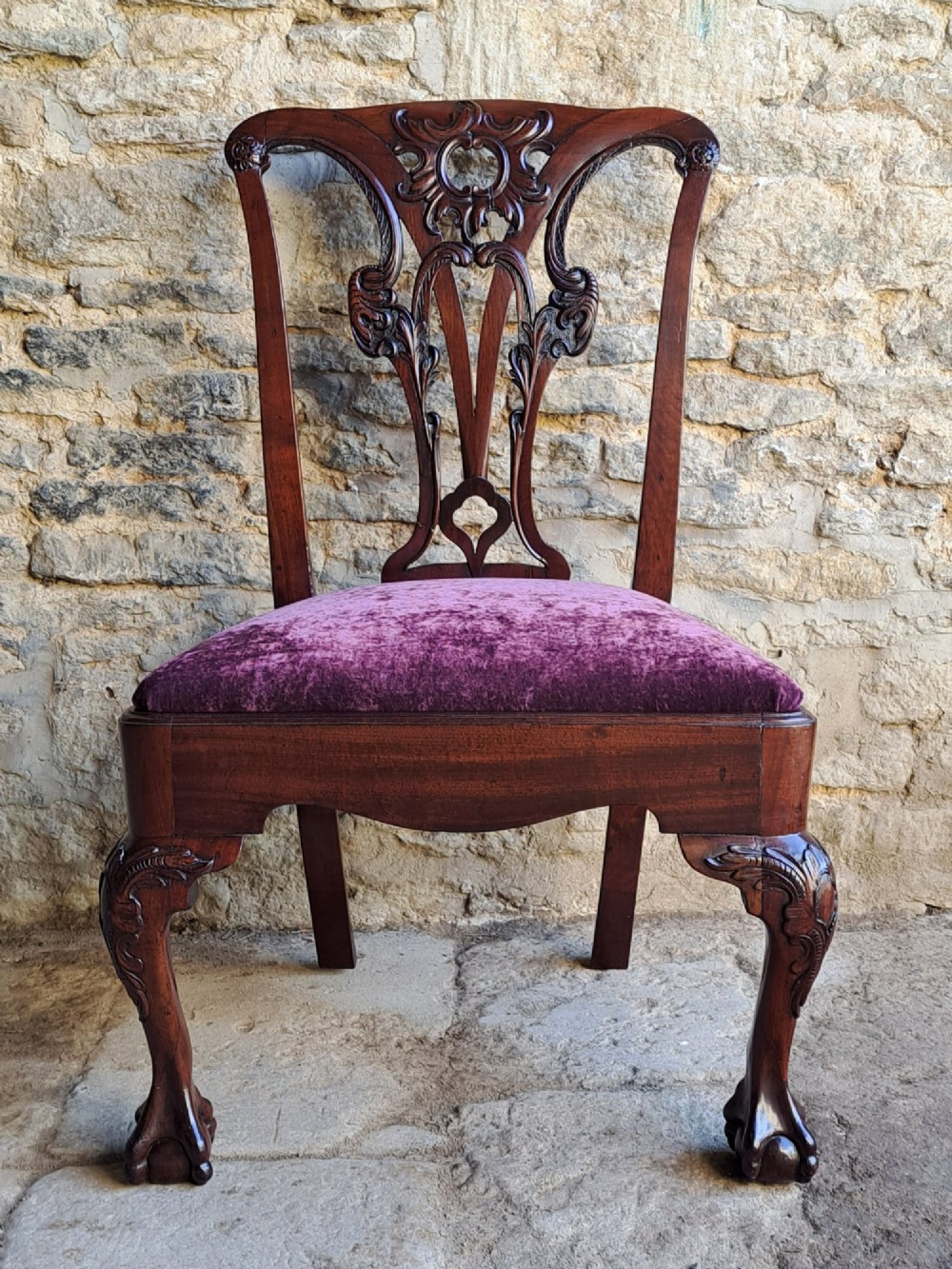 A mid-18th century walnut side chair featuring an intricate carved splat back, purple velvet drop-in seat, and cabriole legs ending in ball and claw feet. View II