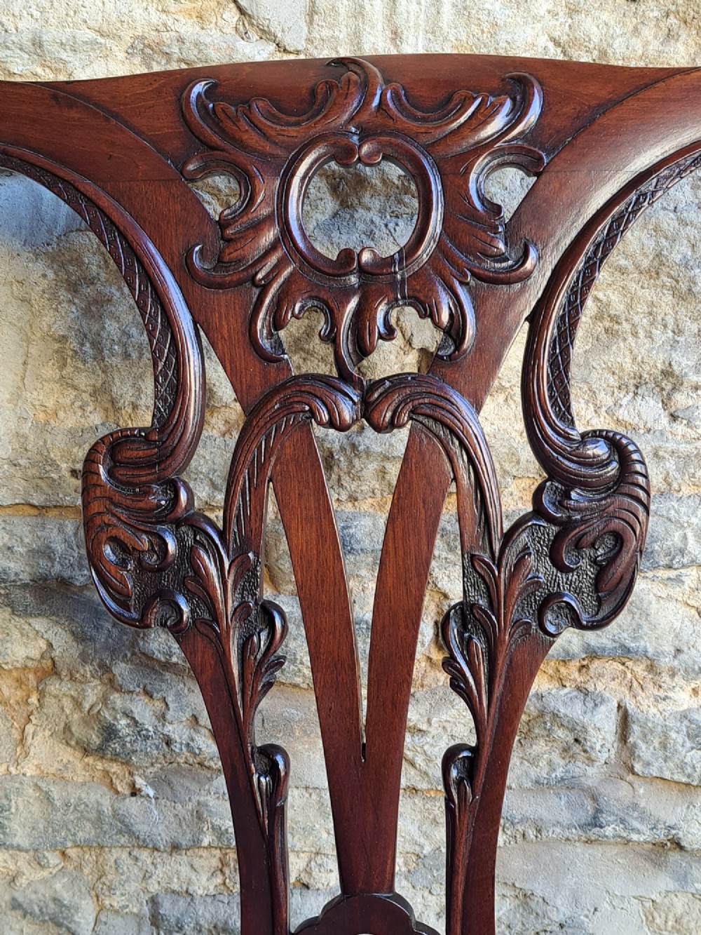 A mid-18th century walnut side chair featuring an intricate carved splat back, purple velvet drop-in seat, and cabriole legs ending in ball and claw feet. View V