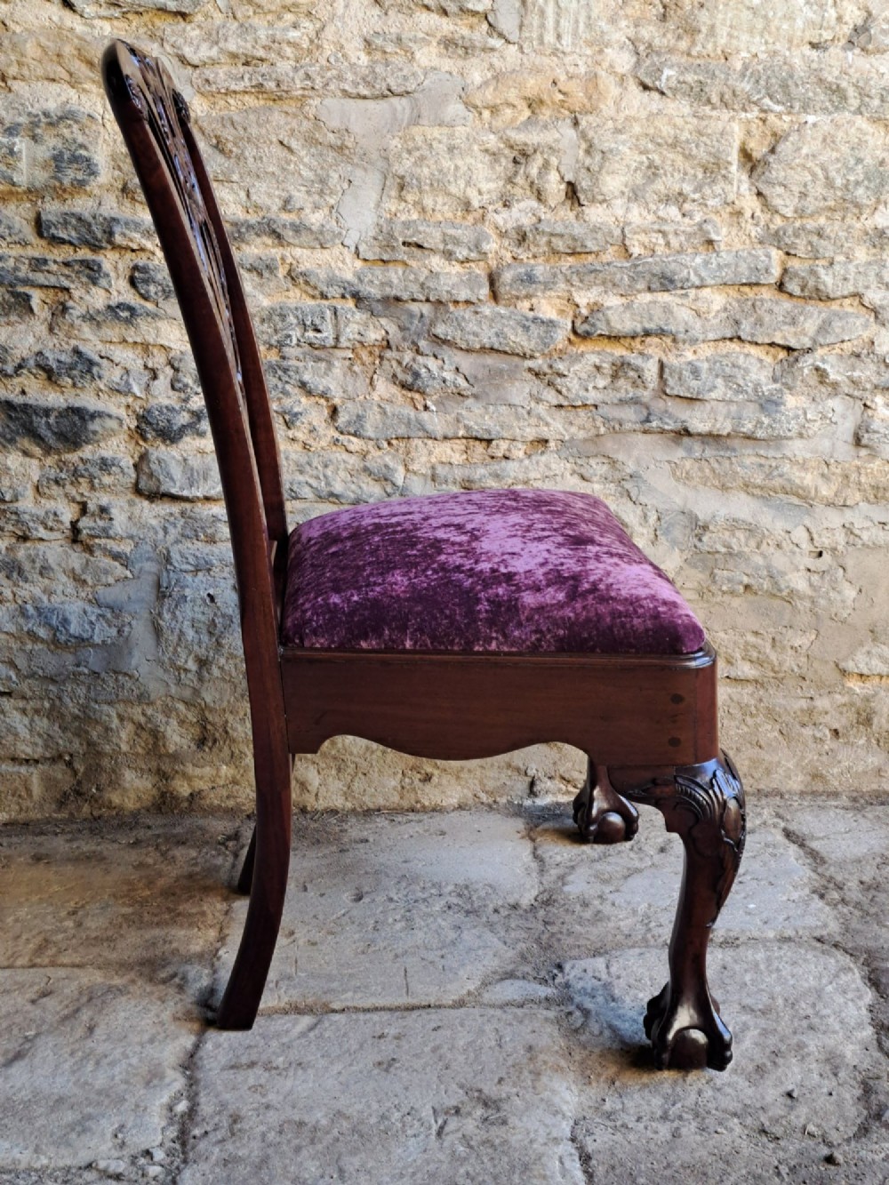 A mid-18th century walnut side chair featuring an intricate carved splat back, purple velvet drop-in seat, and cabriole legs ending in ball and claw feet. View VIII