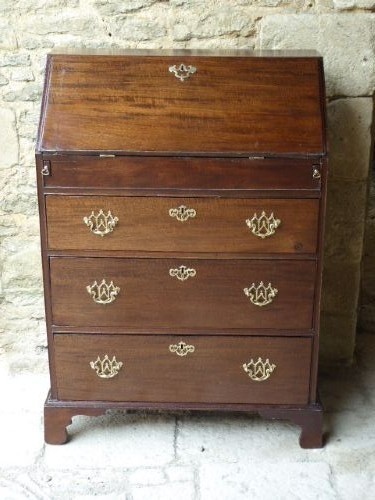 An eighteenth-century Georgian dark mahogany writing bureau with an open slant lid showing interior pigeonholes above three drawers with brass hardware. View II