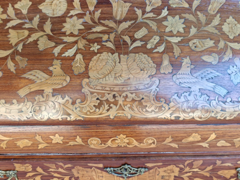 An antique Dutch walnut cylinder bureau decorated with floral marquetry inlays, resting on slender cabriole legs. View IV