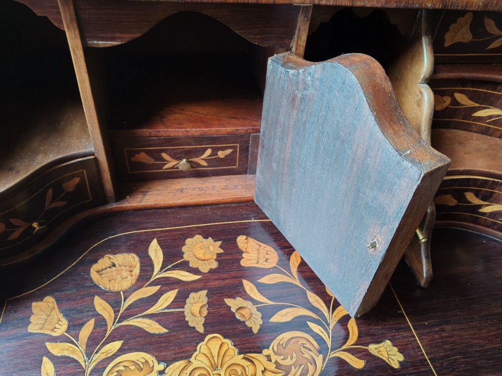 An antique Dutch walnut cylinder bureau decorated with floral marquetry inlays, resting on slender cabriole legs. View XIII