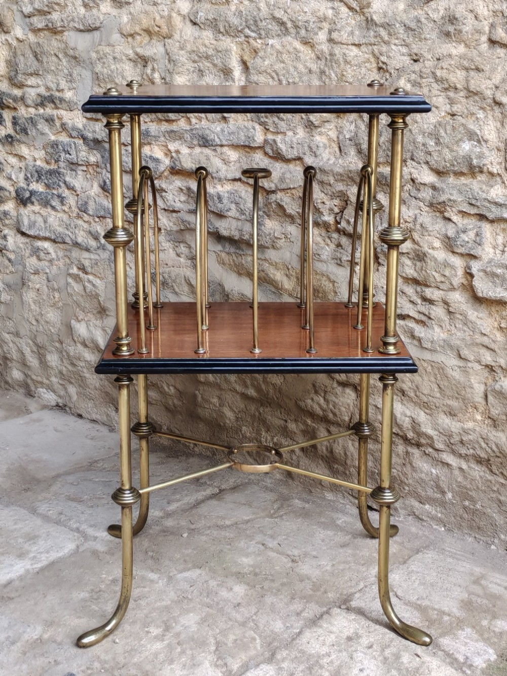 A Regency style two-tier table featuring a polished mahogany top, brass frame with vertical dividers for periodicals, and curved brass legs. View II