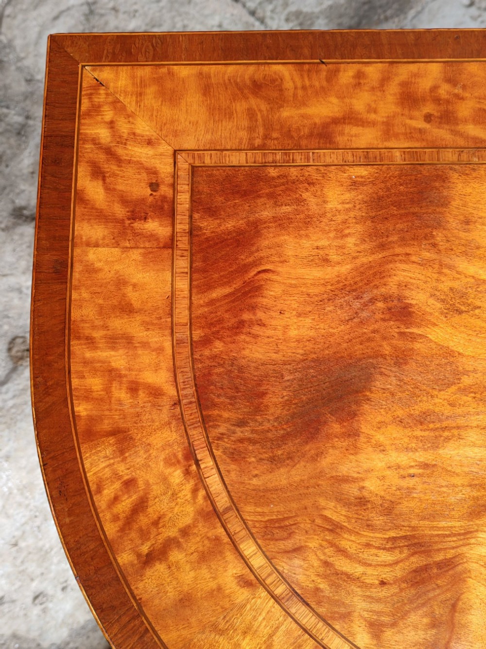 A late 18th-century D-shaped satinwood card table with fine crossbanding, stringing inlay, and square tapered legs. View III