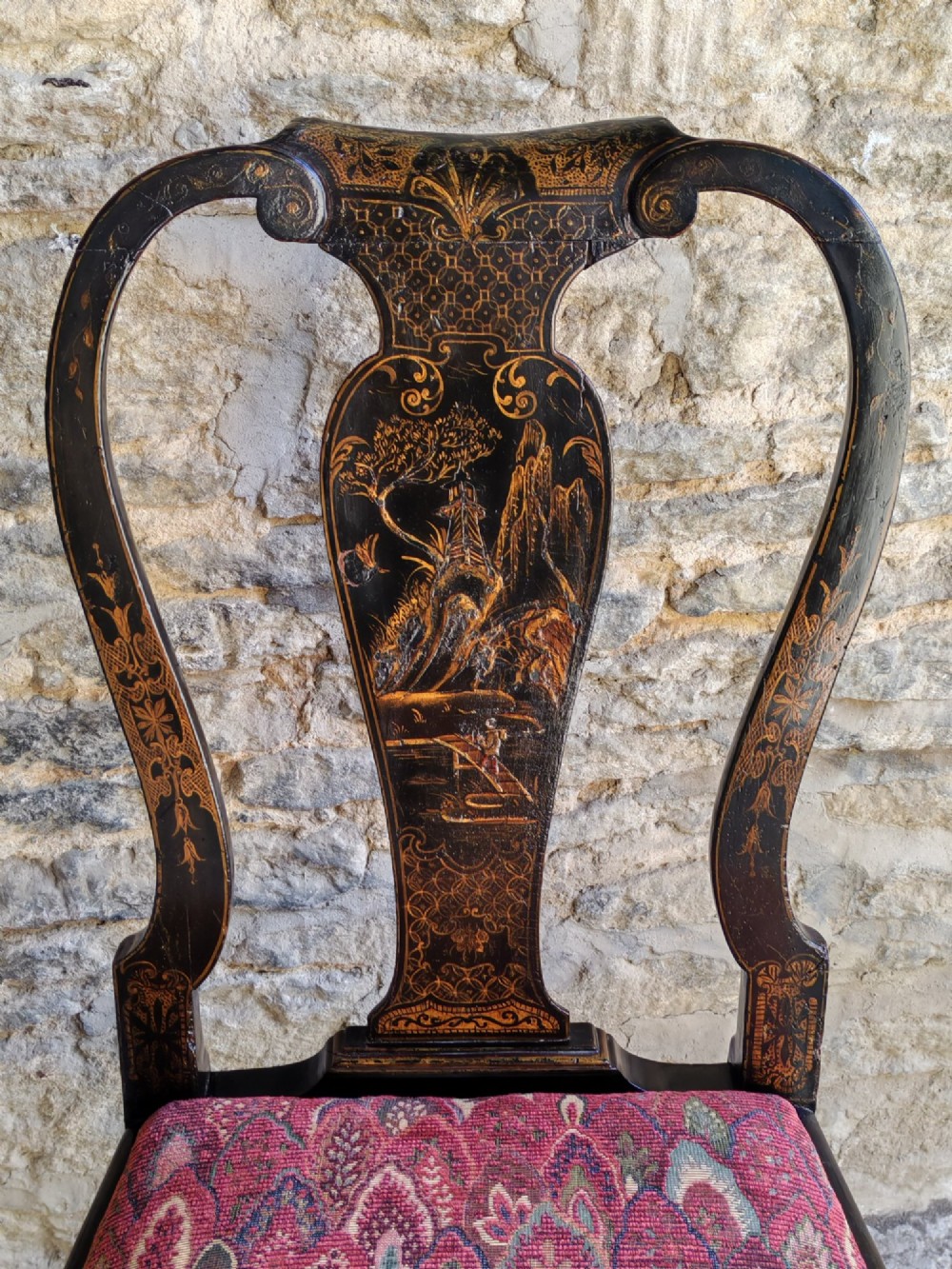 An early 18th-century Queen Anne side chair featuring black japanned lacquer with detailed gold Chinoiserie decorations, a vase splat back, cabriole legs, and a patterned red upholstery seat. View III