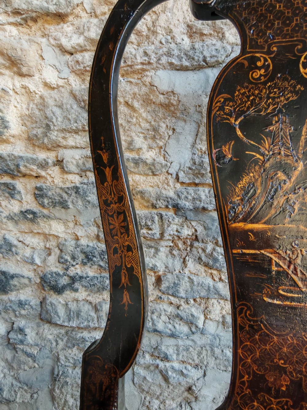 An early 18th-century Queen Anne side chair featuring black japanned lacquer with detailed gold Chinoiserie decorations, a vase splat back, cabriole legs, and a patterned red upholstery seat. View VII