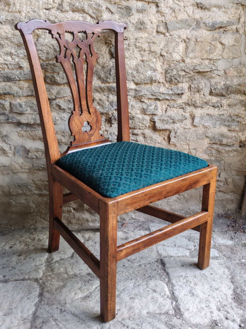 An 18th-century Georgian Chippendale style elm side chair featuring a carved pierced splat back, square legs with an H-stretcher, and a patterned green upholstered seat. View II