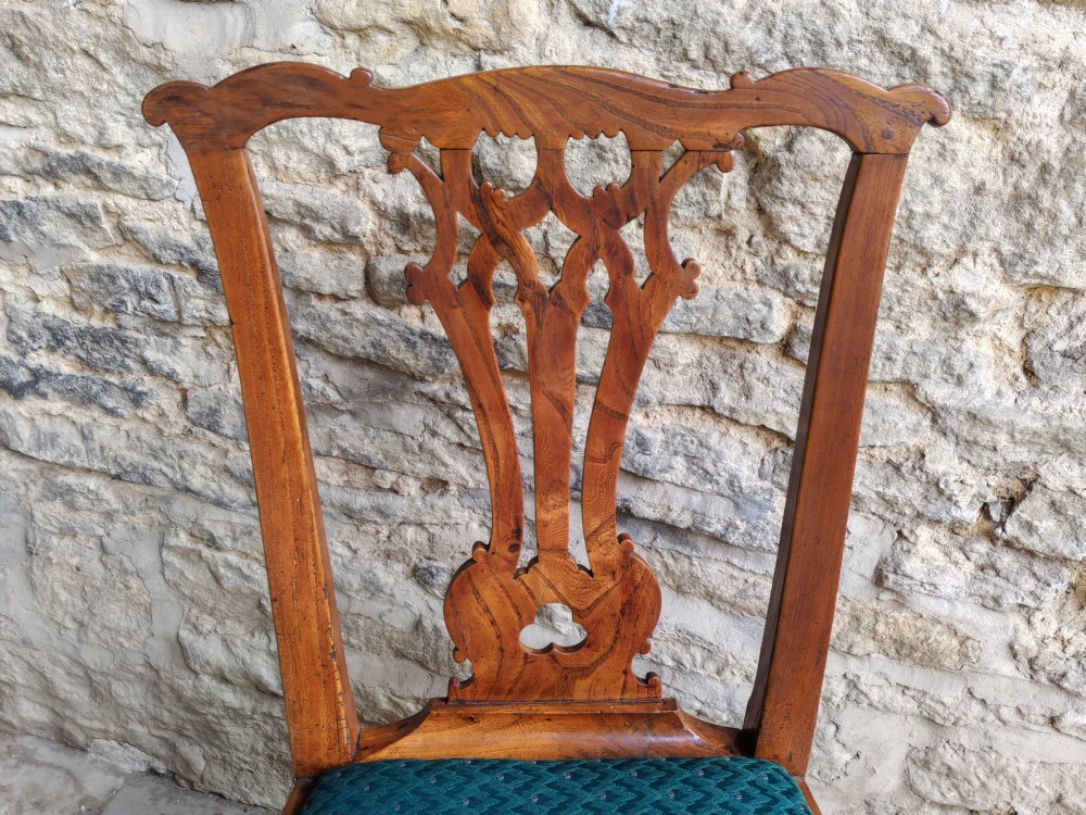 An 18th-century Georgian Chippendale style elm side chair featuring a carved pierced splat back, square legs with an H-stretcher, and a patterned green upholstered seat. View IV