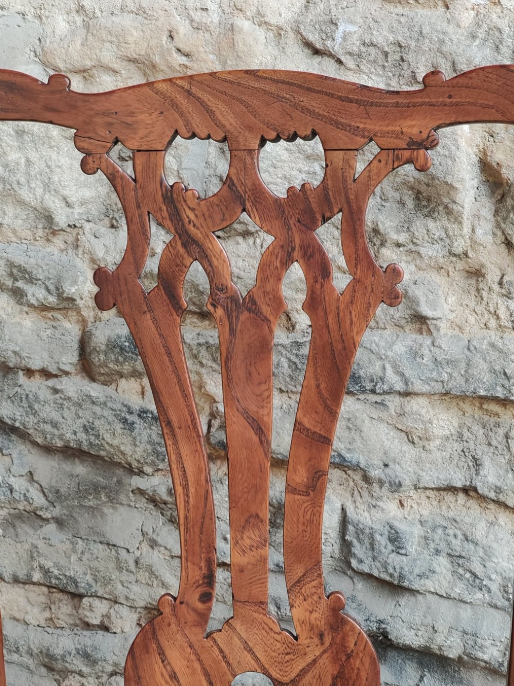 An 18th-century Georgian Chippendale style elm side chair featuring a carved pierced splat back, square legs with an H-stretcher, and a patterned green upholstered seat. View VI