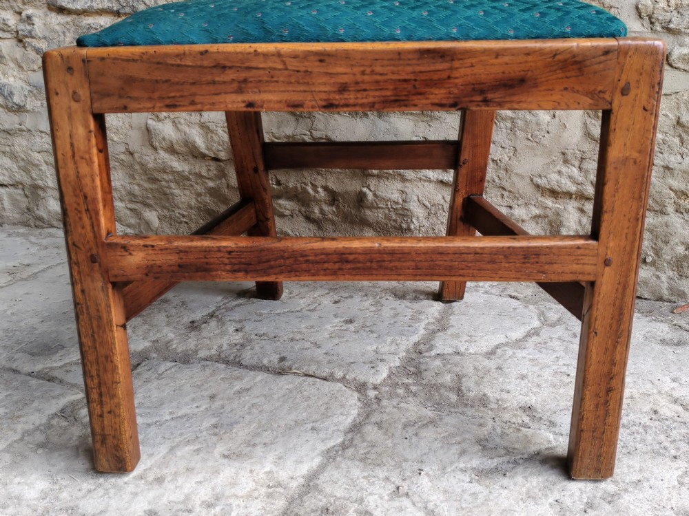 An 18th-century Georgian Chippendale style elm side chair featuring a carved pierced splat back, square legs with an H-stretcher, and a patterned green upholstered seat. View VIII