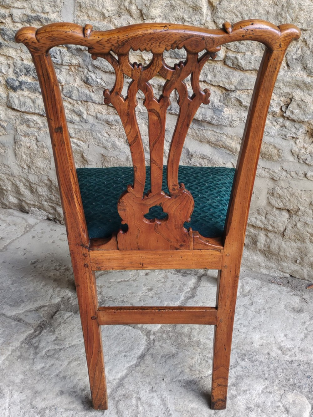 An 18th-century Georgian Chippendale style elm side chair featuring a carved pierced splat back, square legs with an H-stretcher, and a patterned green upholstered seat. View IX