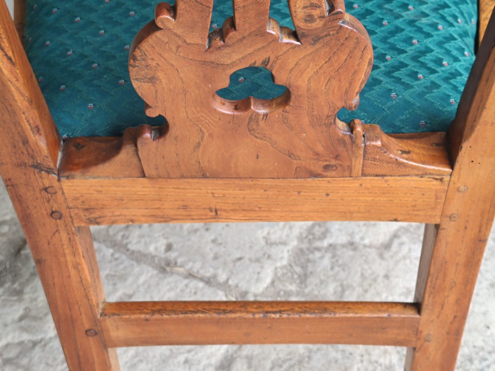 An 18th-century Georgian Chippendale style elm side chair featuring a carved pierced splat back, square legs with an H-stretcher, and a patterned green upholstered seat. View X