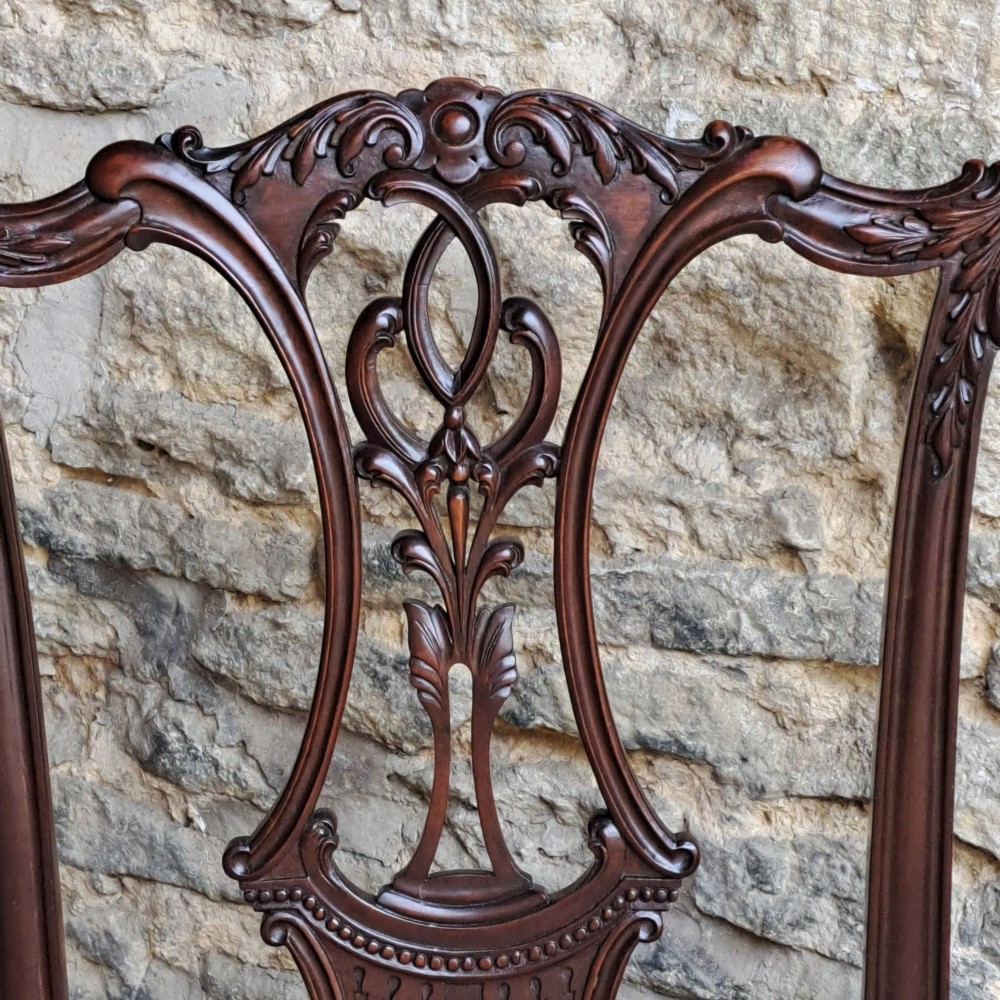 A mid 19th-century mahogany Chippendale style side chair featuring a carved pierced back splat, patterned fabric seat, and cabriole legs with ball and claw feet. View IV