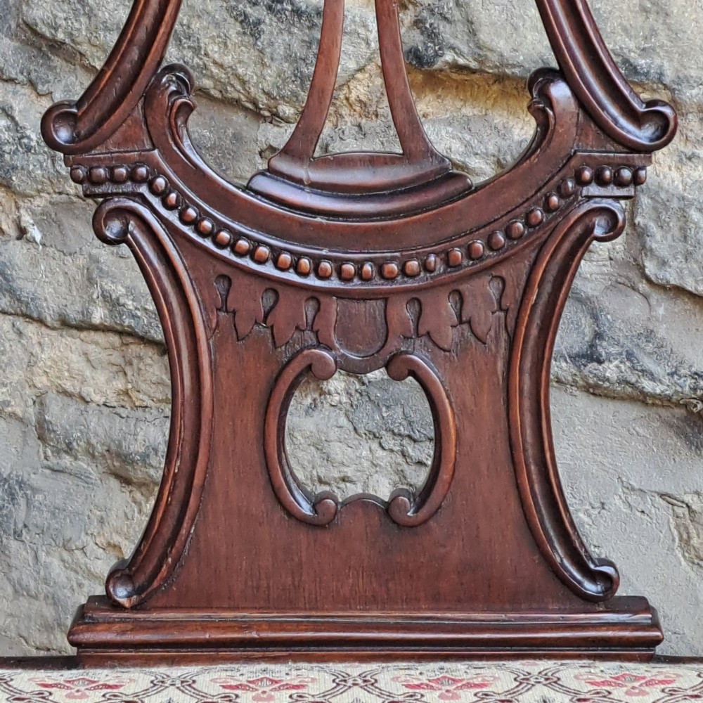 A mid 19th-century mahogany Chippendale style side chair featuring a carved pierced back splat, patterned fabric seat, and cabriole legs with ball and claw feet. View VI
