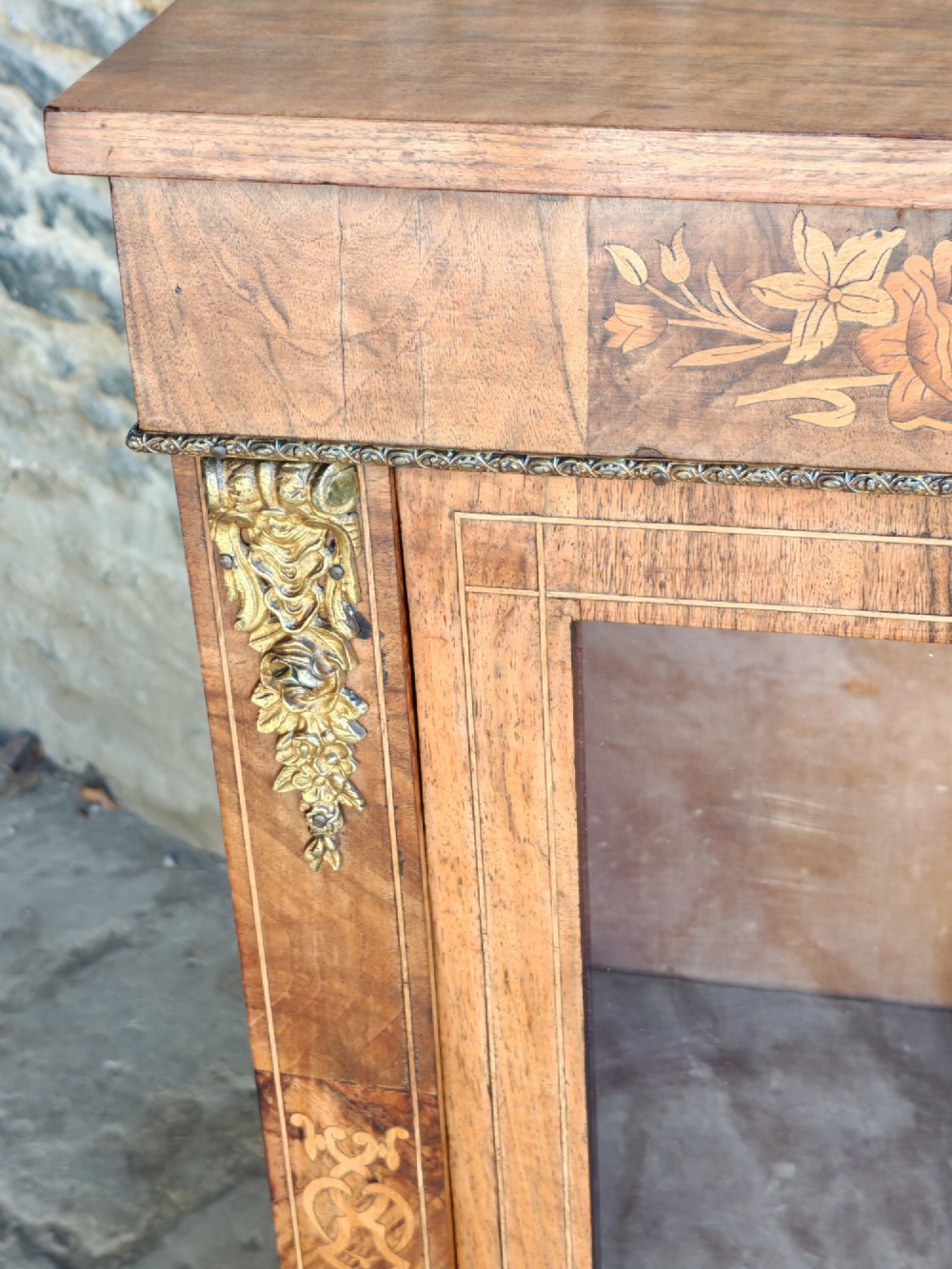 A Victorian walnut pier cabinet featuring floral marquetry inlay, gilt-bronze mounts, and a single glazed glass door opening to two interior shelves. View III
