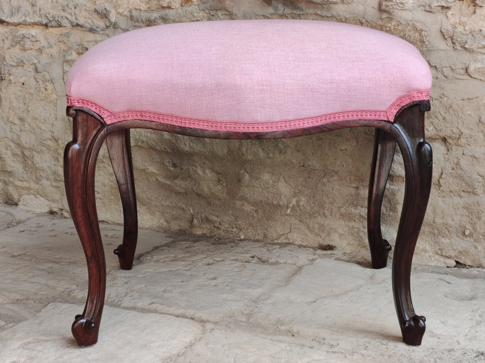 An antique rosewood stool featuring carved cabriole legs and a pink upholstered seat. View II