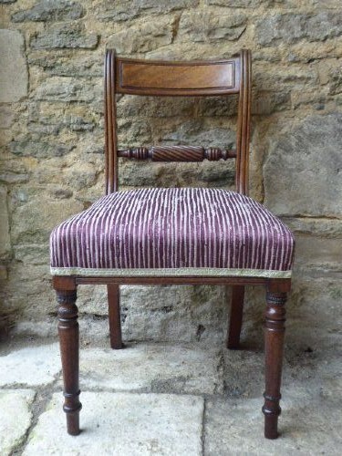 A set of four Regency mahogany dining chairs featuring carved rope-twist cross rails, reeded uprights, turned front legs, and plum striped upholstered seats. View III