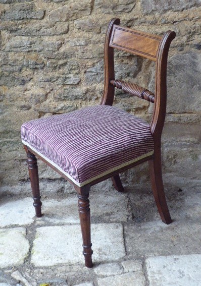 A set of four Regency mahogany dining chairs featuring carved rope-twist cross rails, reeded uprights, turned front legs, and plum striped upholstered seats. View VI