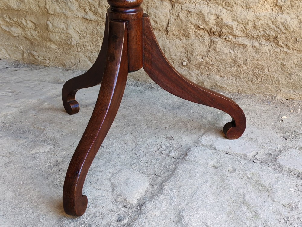 An antique Regency yew wood wine table featuring a rectangular rounded top supported by a turned pedestal stem with ebonised rings on a tripod base. View VII