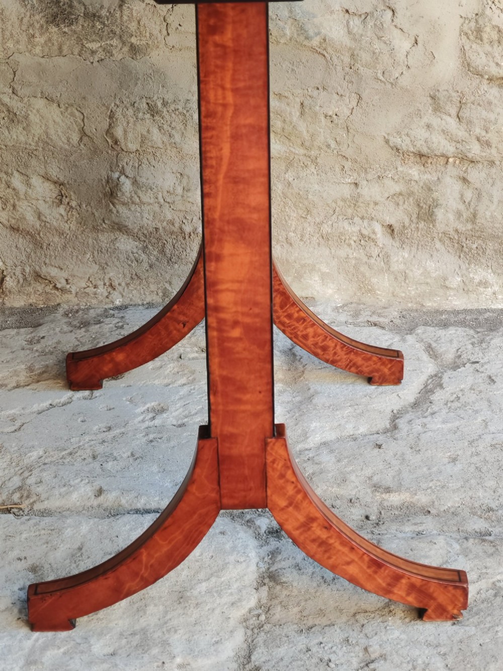 An oval satinwood coffee table featuring double band inlay on the tabletop and supported by twin trestle legs connected by a central stretcher. View VI
