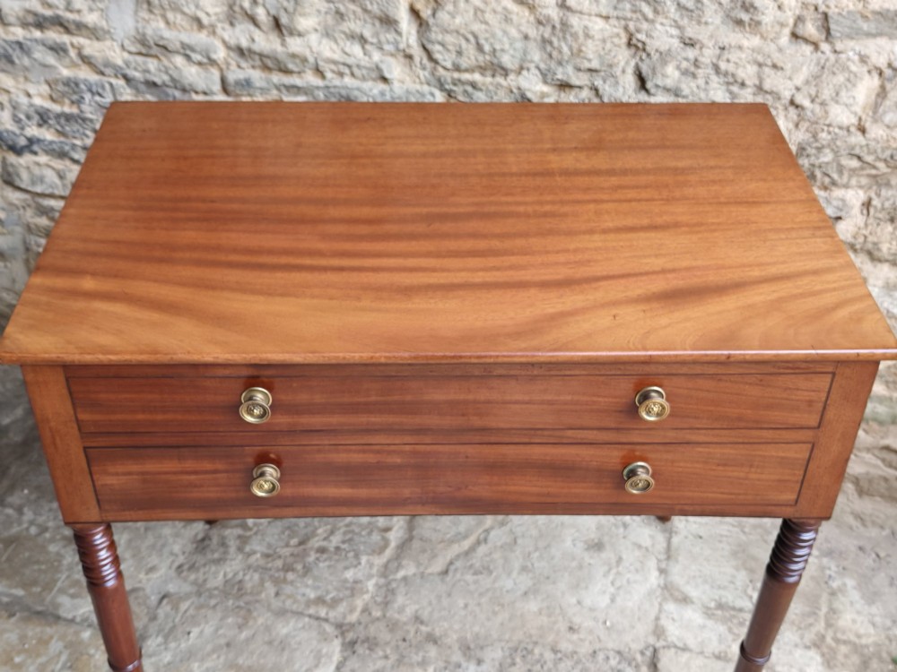 A mid-19th century mahogany work table with an open hinged lid revealing a removable fitted compartment tray set atop turned legs. View IV