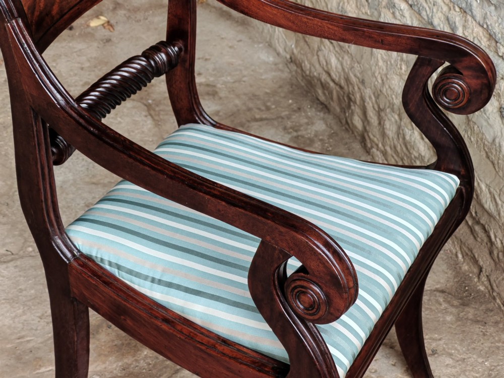 A pair of Regency mahogany carver armchairs with rope-twist rail splats, reeded sweeping arms, and blue striped fabric seats. View VI