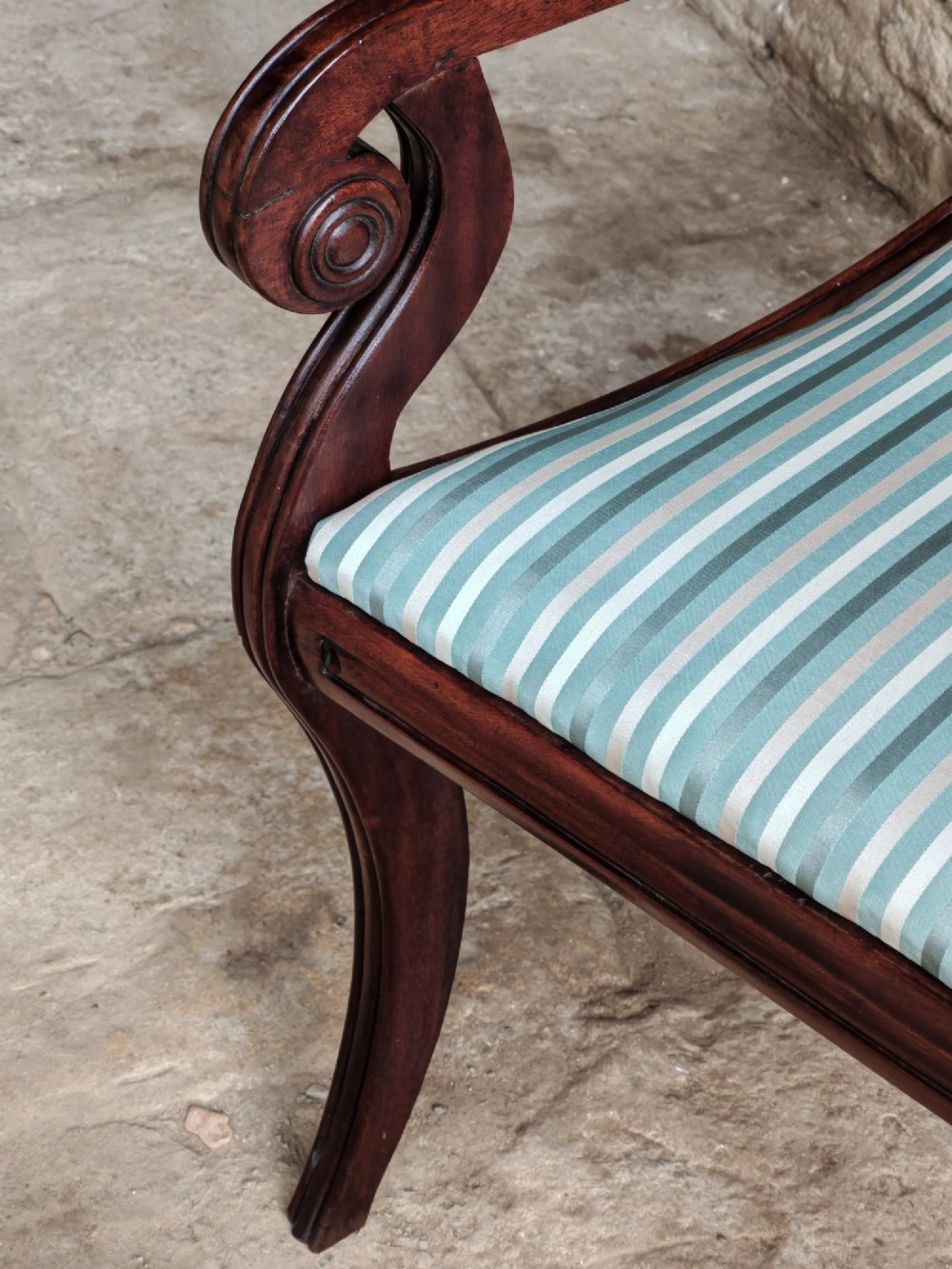 A pair of Regency mahogany carver armchairs with rope-twist rail splats, reeded sweeping arms, and blue striped fabric seats. View VIII