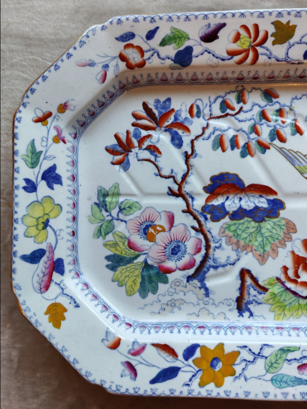 An octagonal Masons ironstone meat platter decorated with a multi-coloured hand-painted chinoiserie motif featuring a bird, flowering branches, and integrated drainage grooves. View III