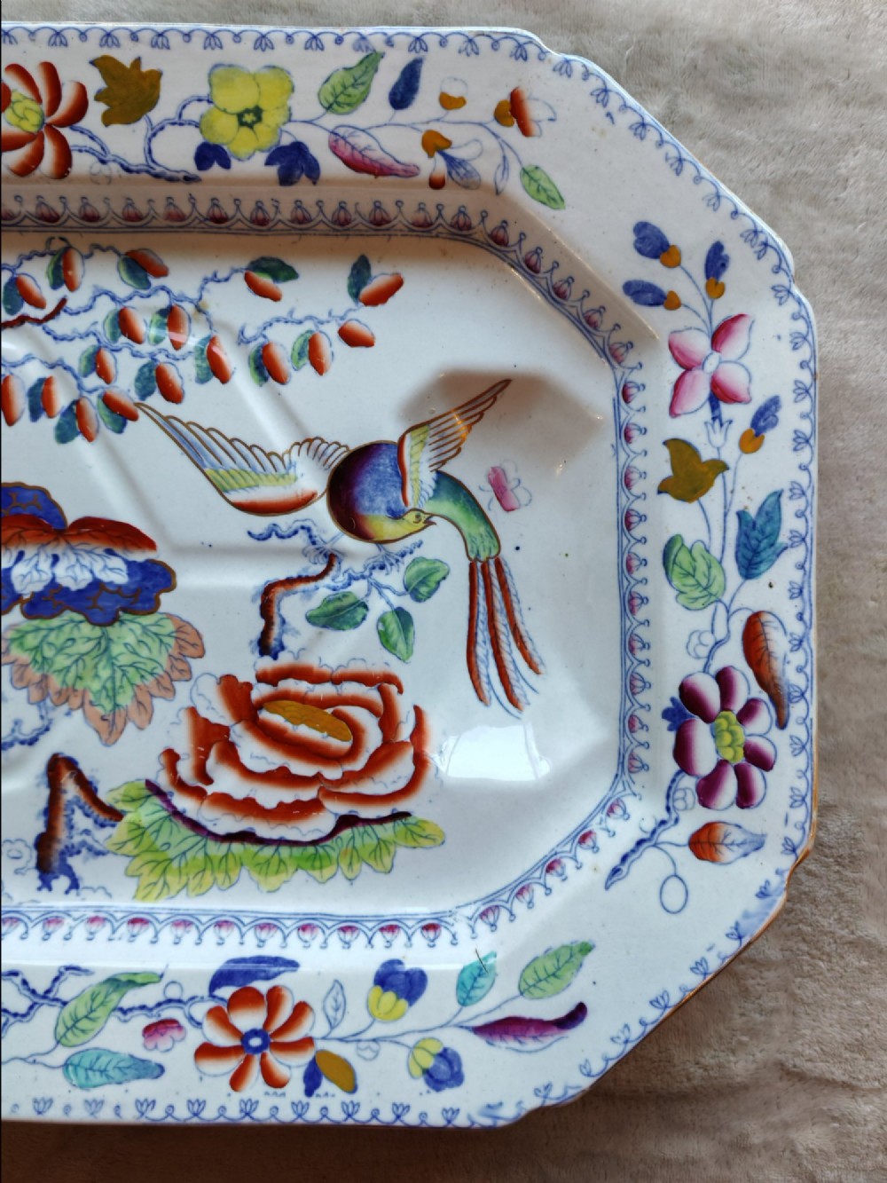 An octagonal Masons ironstone meat platter decorated with a multi-coloured hand-painted chinoiserie motif featuring a bird, flowering branches, and integrated drainage grooves. View IV