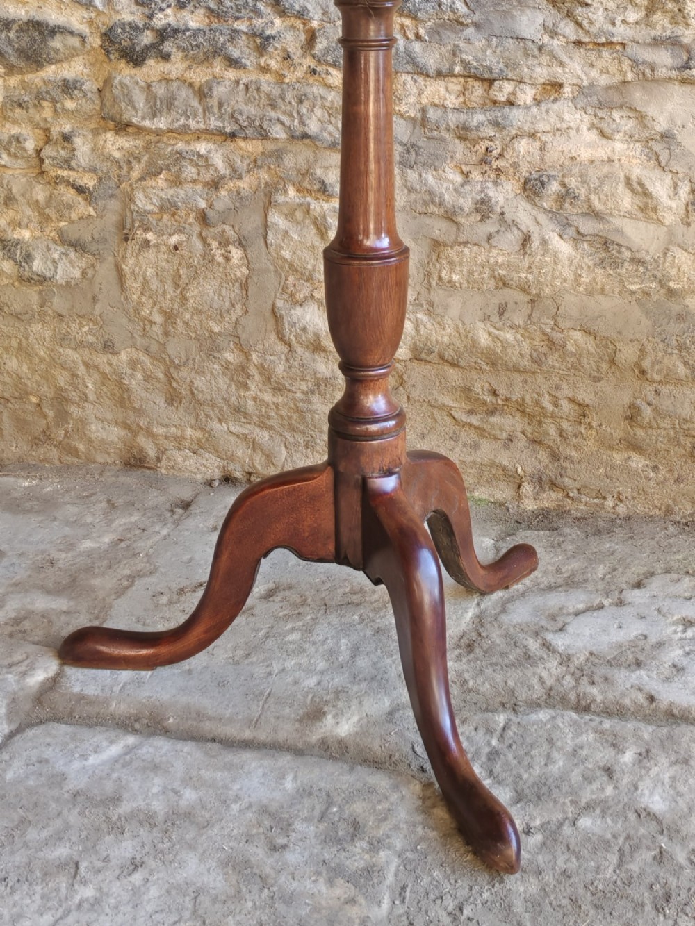 An 18th-century Georgian oak tripod table featuring a circular tilt-top surface positioned vertically on a turned baluster column and three curved legs. View IV