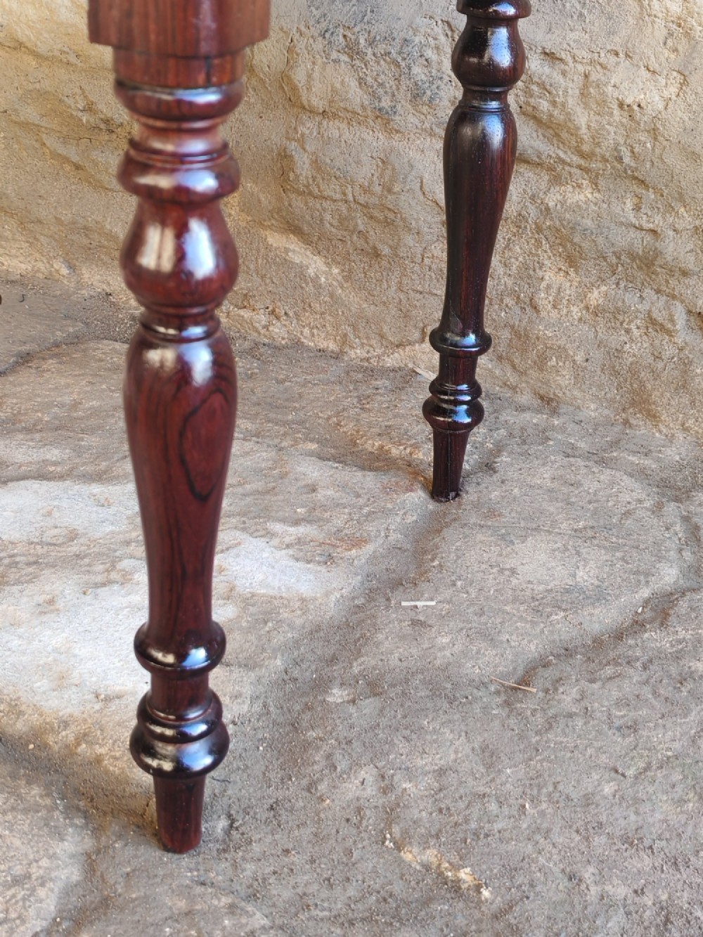 An antique square rosewood stool featuring turned legs and a red velvet upholstered seat. View III