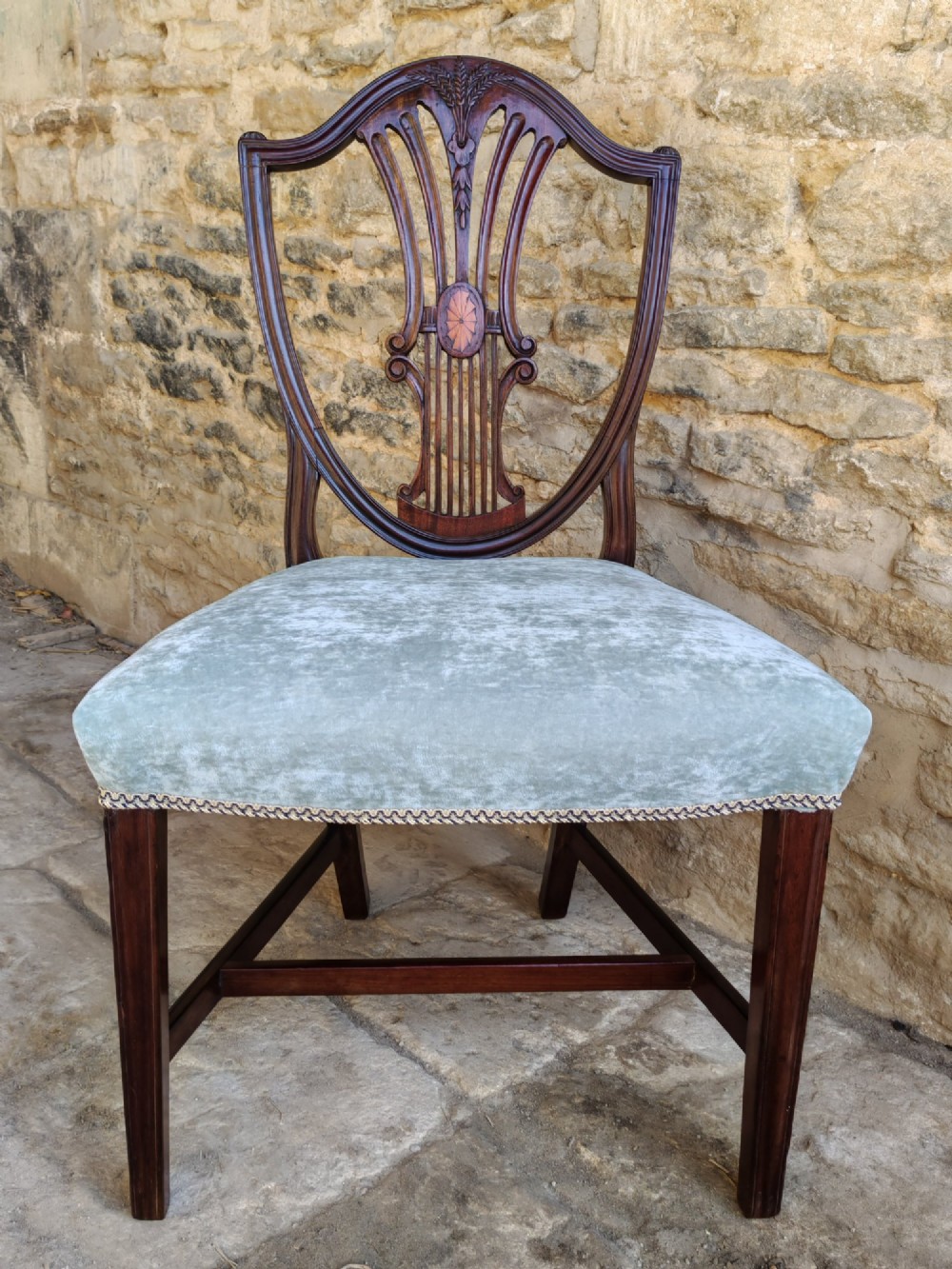 A set of four antique mahogany Hepplewhite dining chairs featuring carved shield-shaped backs with central inlay motifs and light green upholstered seats. View VIII