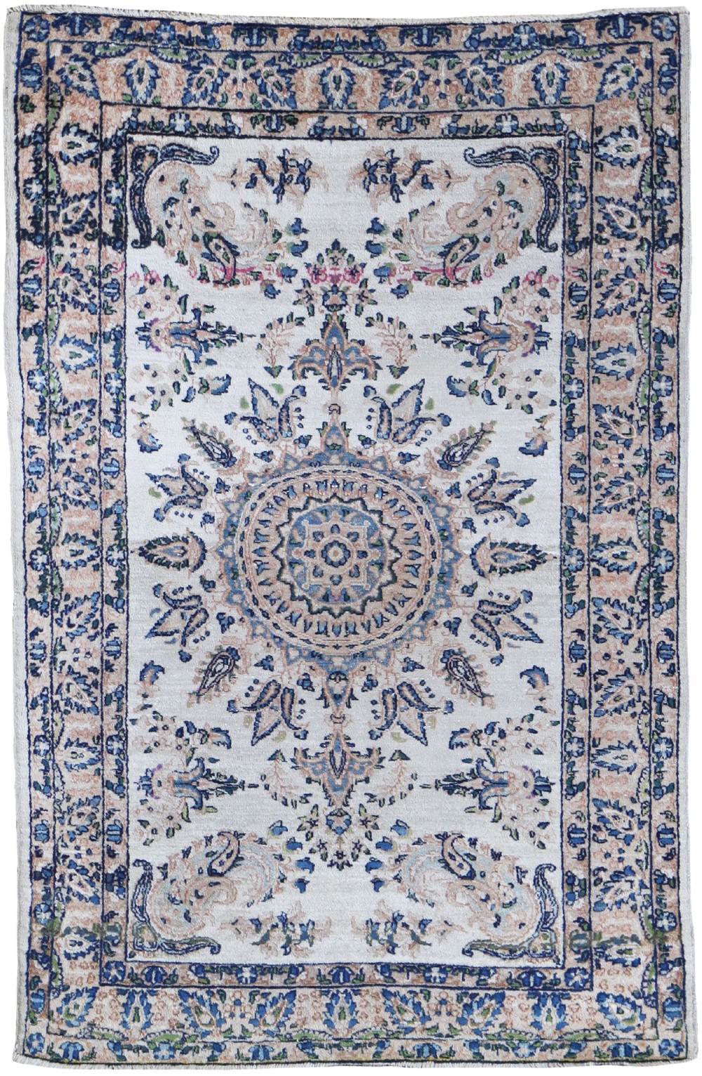 An antique hand-knotted Persian Kirman wool rug featuring a central medallion on an ivory field surrounded by elaborate floral borders in blue and pink tones.
