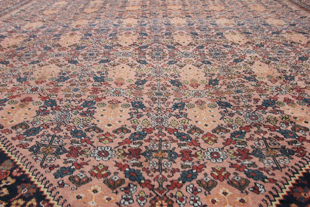 An antique Persian Mahal hand-knotted wool carpet featuring a diamond field in terracotta tones, dark floral corner spandrels, and multi-band borders. View II