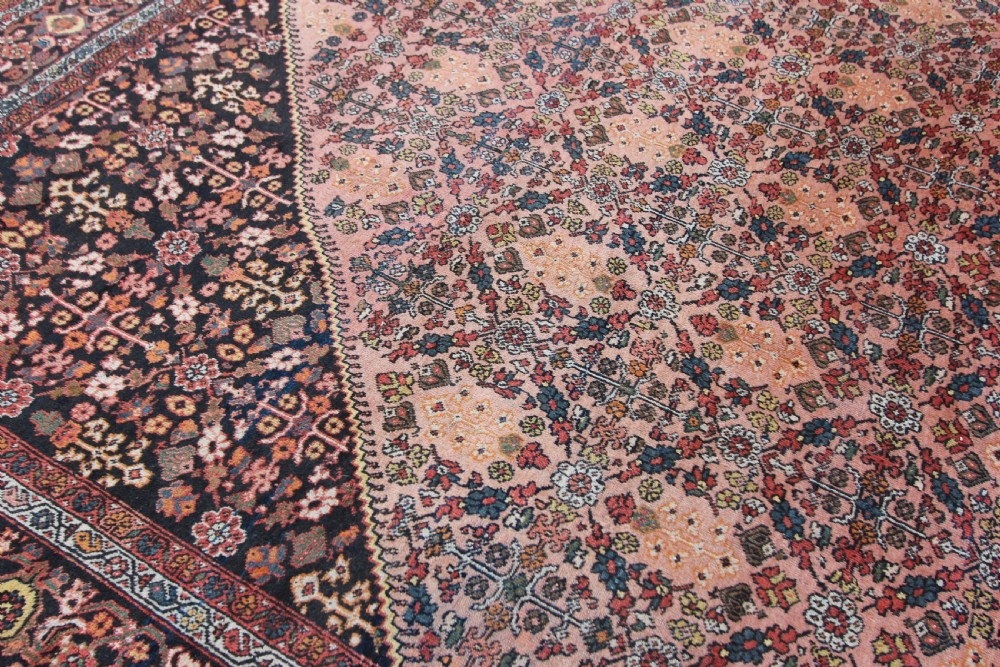 An antique Persian Mahal hand-knotted wool carpet featuring a diamond field in terracotta tones, dark floral corner spandrels, and multi-band borders. View III