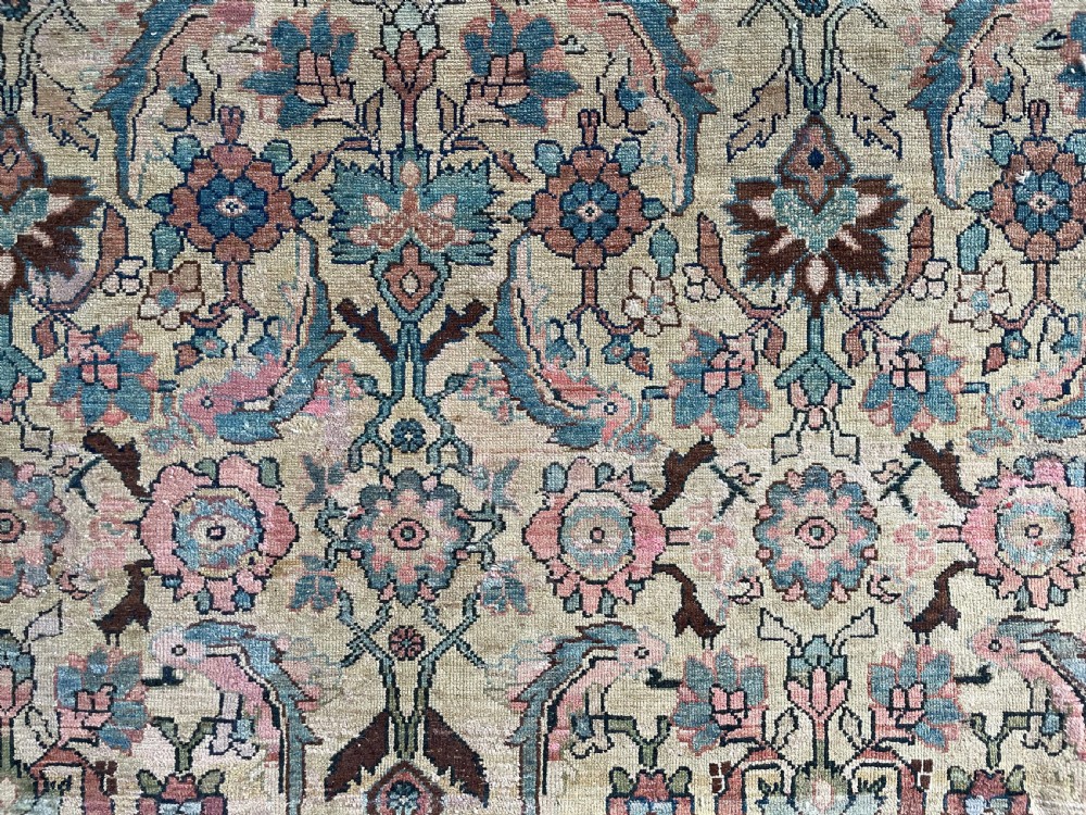 An antique hand-knotted Hamadan carpet featuring an intricate overall floral pattern on a cream field surrounded by a terracotta border. View X